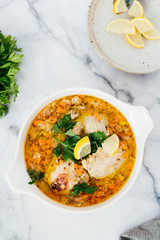 Chicken Escabeche with Fresh Parsley on Marble Background