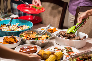 Buffet dinner with red meat, salads and side dishes