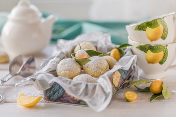 Lemon cookie in a metal box on a white wooden table