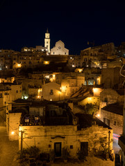 Fototapeta na wymiar Italy, april 2019: Sassi is an ancient district of Matera by night, landscape by night, night lights