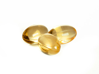 yellow capsules with fish oil, source of vitamins, isolated on white background