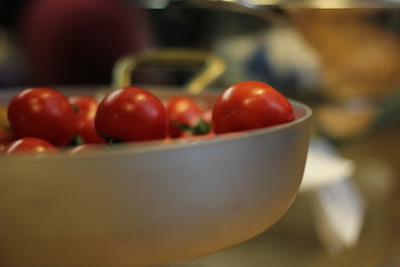 Cherry tomatoes close up inside a bowl. Close up of Cherry tomatoes inside a bowl in a market.  Cherrytomaten inside metal gray bowl. close up