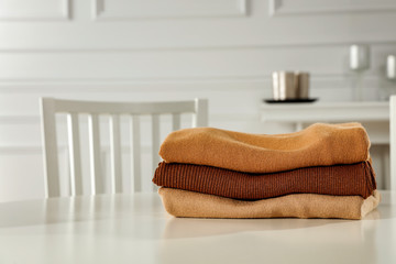 Desk of free space and winter sweaters. Xmas home interior 