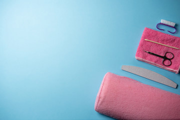 Top view of manicure and pedicure equipment on blue background