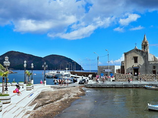 Fototapeta na wymiar Italy,Calabria-pier and church in Lipari