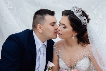 Happy bride and groom on their wedding day. Happy wedding couple hugging. Close up portrait of sexy...