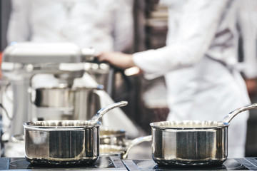 Group of professional chefs work in a restaurant or hotel and prepare a meals (reduced tone)
