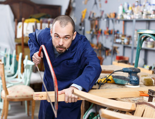 Craftsman in process of creation furniture