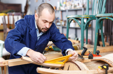 Carpenter using tools for creating  furniture