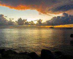 Panorama of beautiful sunset over ocean and sailboats