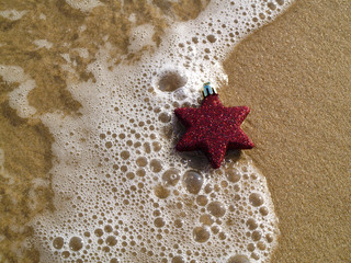 Christmas star decoration at the shore. Christmas at the beach concept.