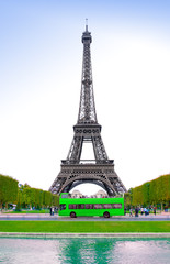 Fototapeta na wymiar view of Eiffel Tower and green bus with tourists visiting Paris city