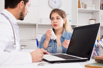 Girl with sore throat visiting  doctor