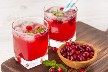 Red coctail with cranberry, vodka and ice. Refreshment drink.