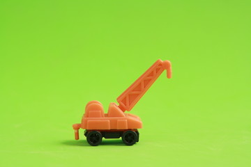 plastic toy with crane shape in color background