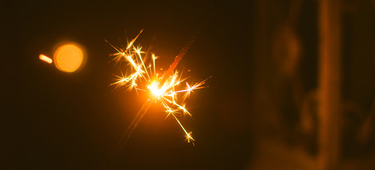 Christmas sparklers in a cozy festive atmosphere in a cozy room with a lamp