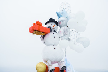 Hello winter. Happy winter time. Snow man. Snow men in hat, scarf, gloves with air balloons and...