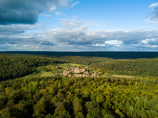 Fototapeta na wymiar Aerial view of the ancient Monastery Bebenhausen, a place of interest close to the city Tuebingen in Germany, during a sunny autumn day.