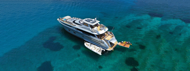 Aerial drone ultra wide photo of luxury yacht docked in tropical exotic island with turquoise sea
