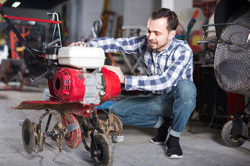 Professional worker is starting to work with plough