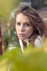 Fototapeta premium Beautiful blonde girl at the door of a wooden cabin