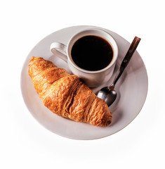 Cup of coffee and croissant for breakfast isolated on a white background.