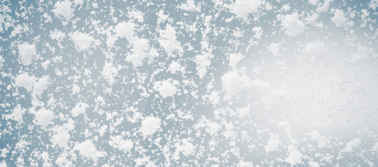 Large snow flakes on the window, macro photo.