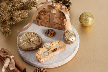 Traditional Italian biscotti or cantuccini cookies on a round white wooden board with cinnamon,...