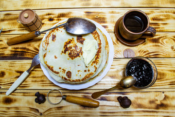 pancakes with butter and jam, Shrovetide a large stack of fried pancakes with tea, selective focus, top view