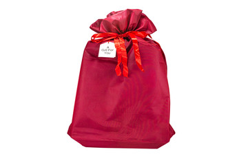 A Christmas gift wrapped in a burgundy fabric with a ribbon, with the inscription 