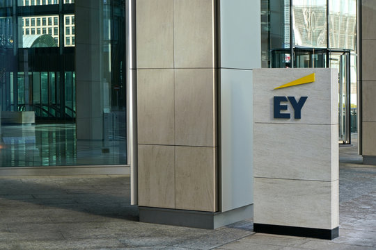 London, United Kingdom - February 03, 2019: Blue and yellow EY signage at entrance to their office in Canary Wharf. It is UK professional services company, one of big 4 accounting firms