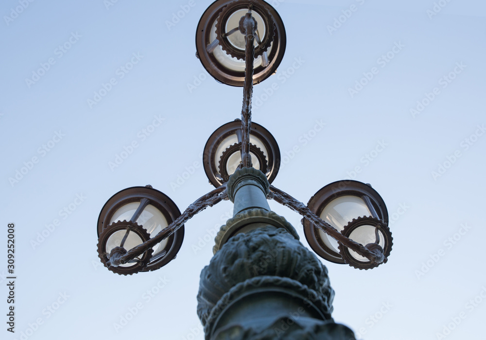 Wall mural vintage street light.black street lamp in an open blue sky . street lantern on background blue sky .