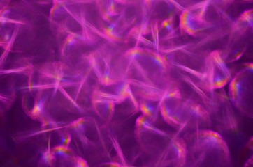 Fototapeta na wymiar Flickering abstract background with defocused purple light