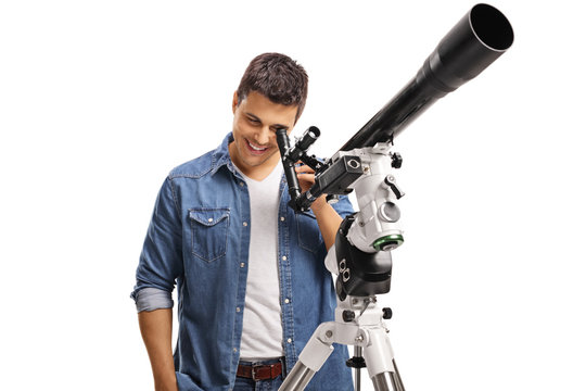 Young man looking through a telescope