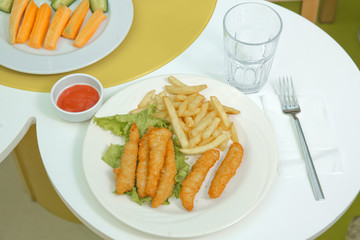 crunchy fried chicken . Schnitzel with french fries and salad . fried chicken and french fries on a wooden background .