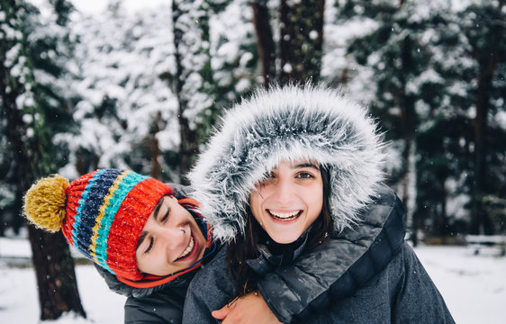 Portrait of happy young couple in winter forest