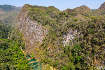 Panorama of the limestone ridge with cascades and waterfalls of Semuc Champey in the Peten jungle and rainforest of Guatemala.