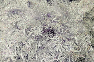 texture silver shiny New year christmas tinsel in the form of fir branches. close-up, soft focus.