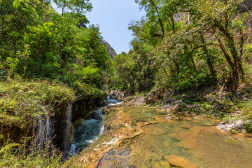 Panorama of the limestone ridge with cascades and waterfalls of Semuc Champey in the Peten jungle and rainforest of Guatemala.