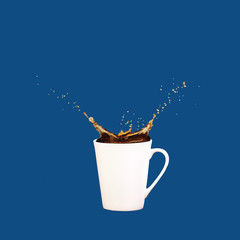 Levitating coffee mug with splashes on solid classic blue background. Coffee concept. Minimal art trend. Square