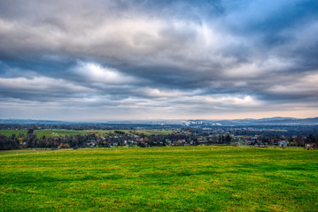 Fototapeta na wymiar industrial valley with beautiful meadow and clouds, Trinec Czech
