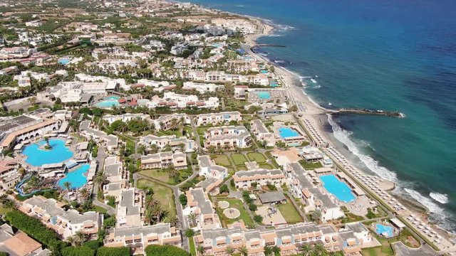 Drone Aerial of Anissaras Coastline Near Hersonissos on Famous Historic Crete Island Greece With Hotel Pools Beaches and Mediterranean Sea Waves