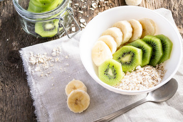 Healthy Breakfast of kiwi, bananas and porridge. Women's diet.