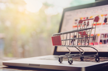 Shopping online. shopping cart or trolley on a laptop keyboard. Shopping service on The online web....