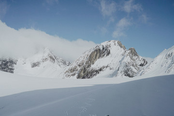 Fototapeta na wymiar Snow White Glacier Mountains with Brilliant Blue Sky