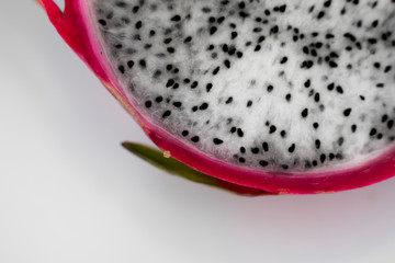 Dragon fruit. Vibrant Dragon Fruit on white background. Sliced white dragon fruit or pitaya on white plate on the table, close-up. Tropical and exotic fruits. Healthy and vitamin food concept.