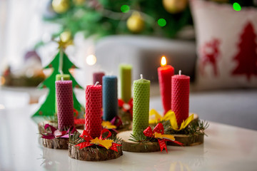 Close shot of natural handmade candles made of beeswax on a wood with christmas decoration
