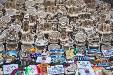 View of traditional tourist souvenirs and gifts from Rome and Vatican, Italy, with fridge magnets with text 