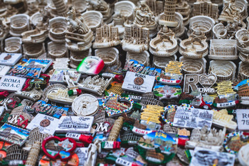 View of traditional tourist souvenirs and gifts from Rome and Vatican, Italy, with fridge magnets...