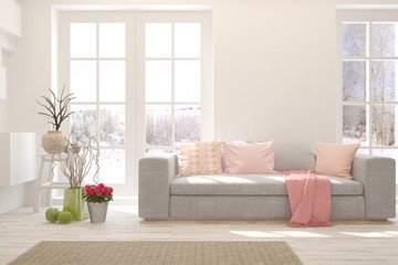 Stylish room in white color with sofa and winter landscape in window. Scandinavian interior design. 3D illustration